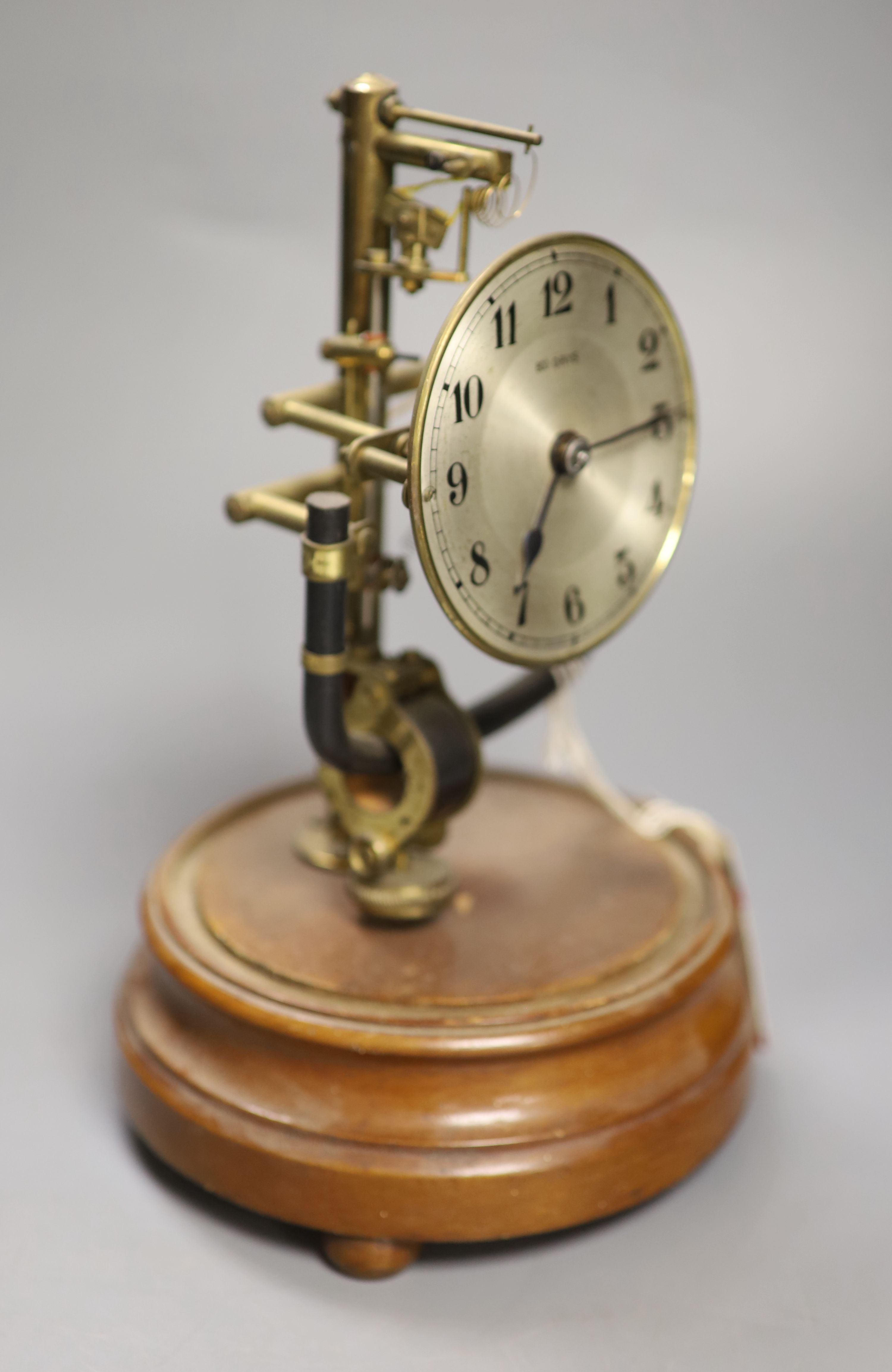 A Bulle type electric mantel clock, under a glass dome, height 26cm